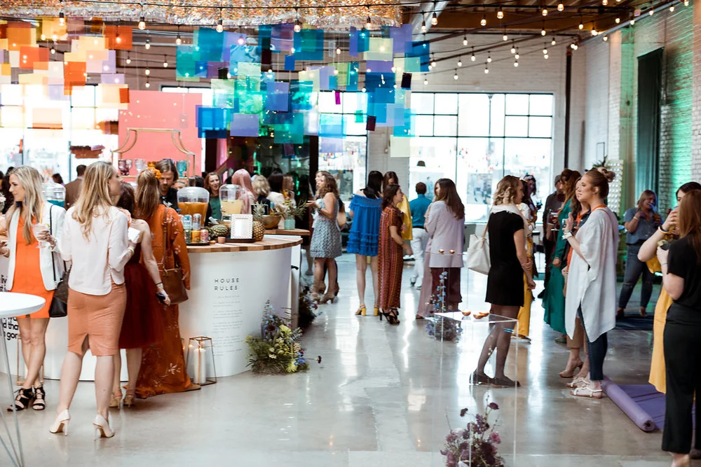Guests gathered at SKYLIGHT in Denver around a circular bar