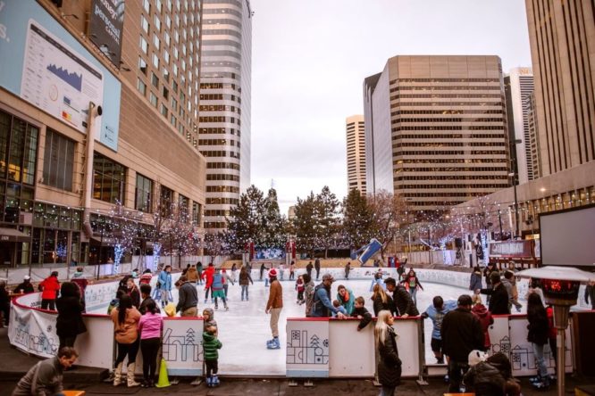 People enjoying an outdoor ice skating rink in Downtown Denver