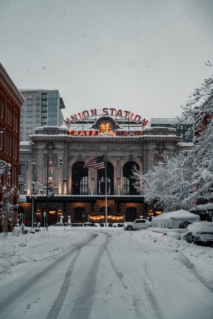 Union Station, a train station in Denver, covered in snow during the holiday season.