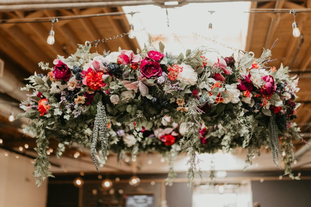 A pink, green, white and yellow floral chandelier at SKYLIGHT in Denver, CO.