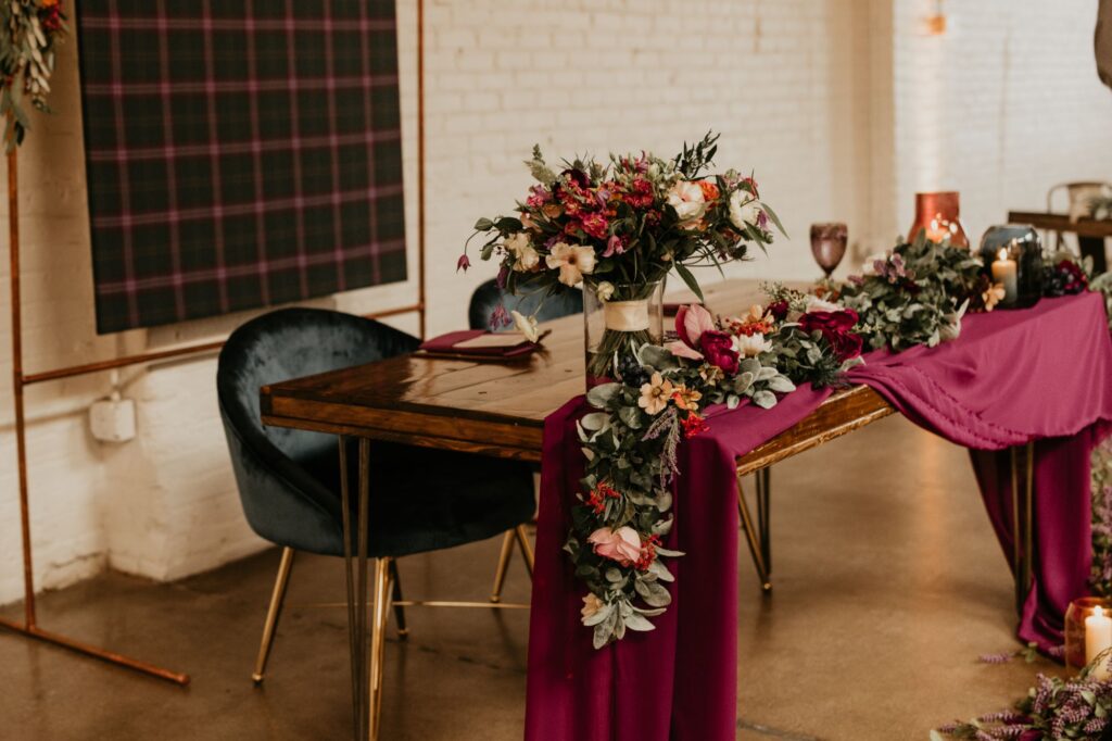 A beautiful sweetheart table with rich jewel tones at SKYLIGHT in Denver, CO.