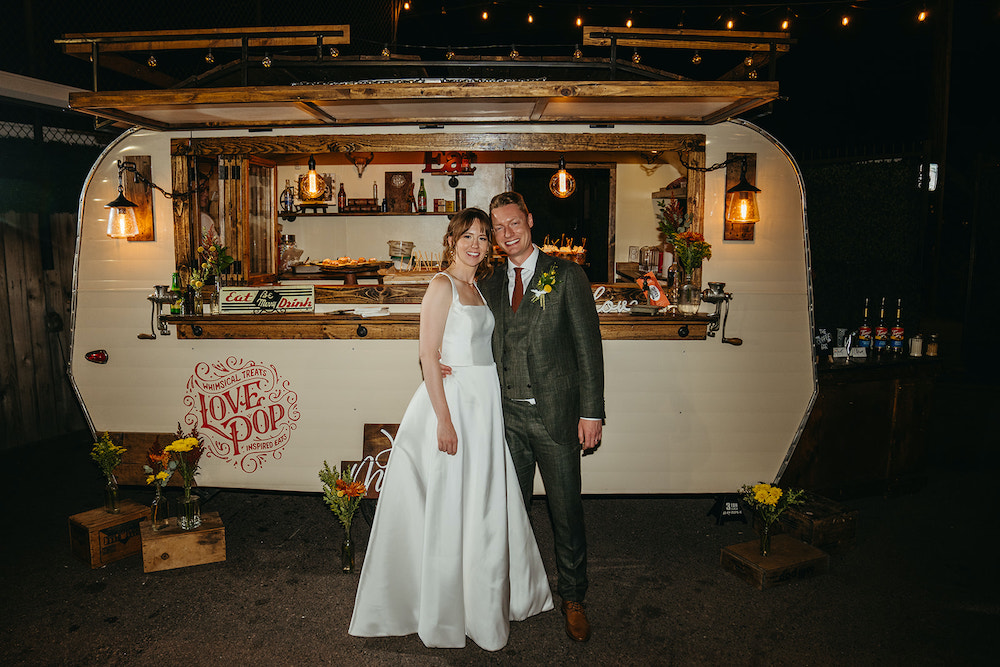 Bride and groom in front of a food truck at SKYLIGHT in Denver