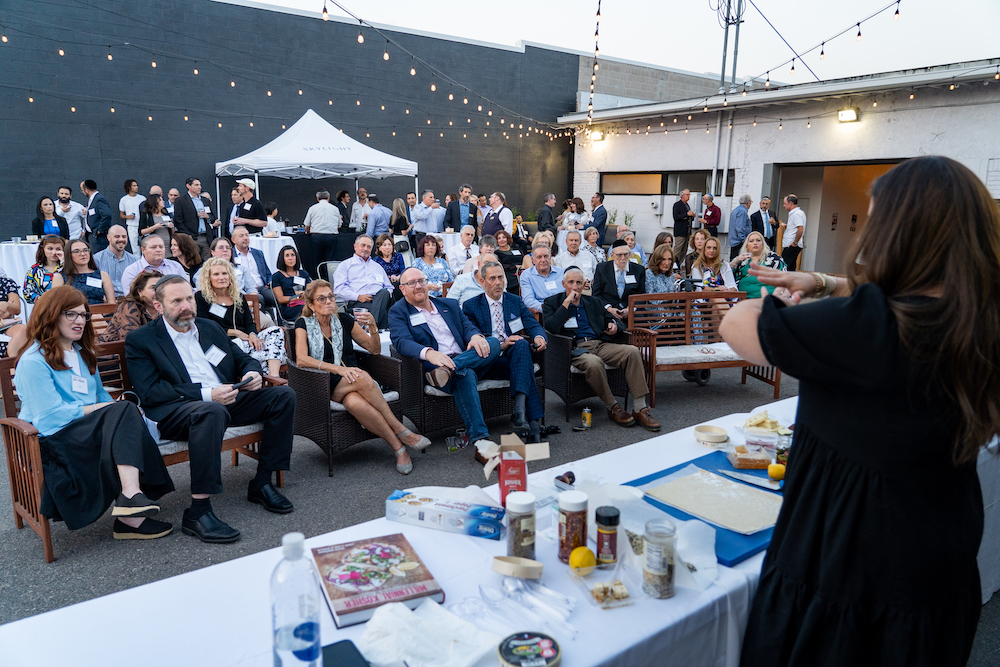 Corporate event watching a demonstration on SKYLIGHT's private patio