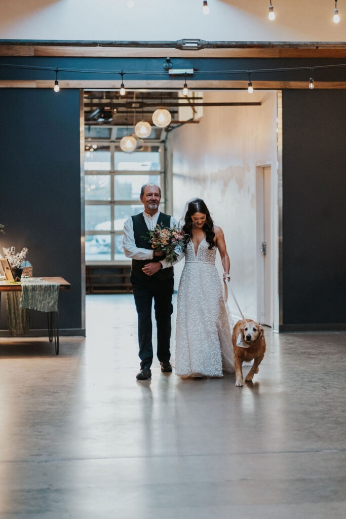 Bride walking her dog down the aisle at SKYLIGHT