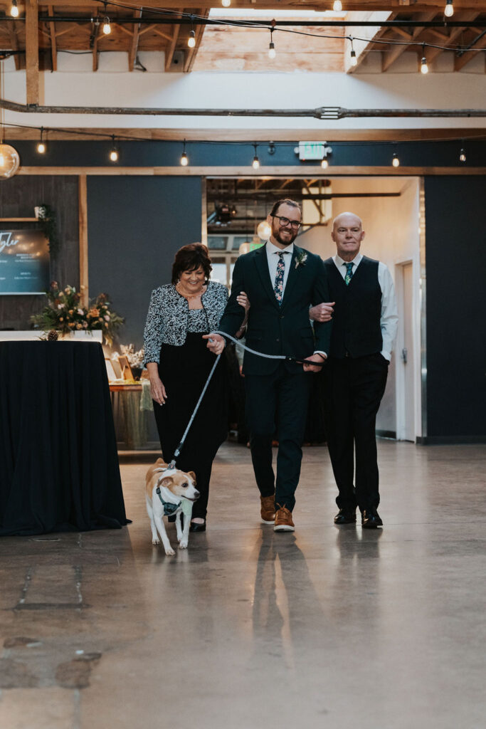 Groom walking his dog down the aisle at SKYLIGHT