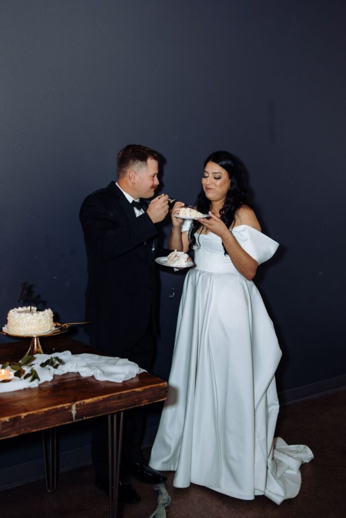 Bride and groom sharing wedding cake