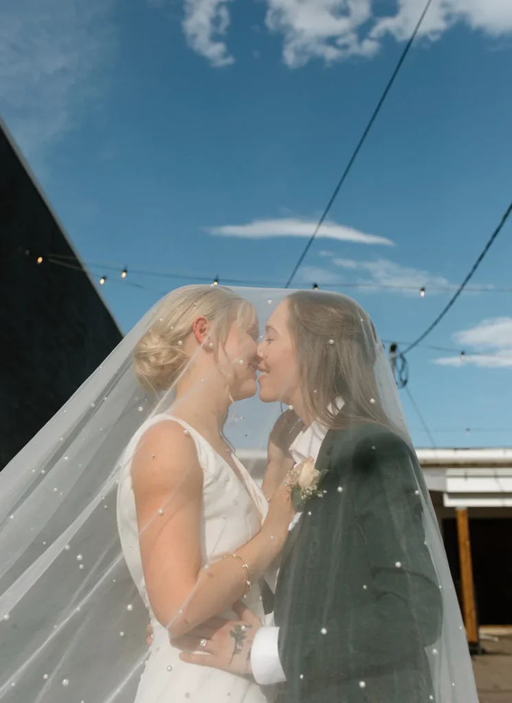 Brides kissing outside of SKYLIGHT