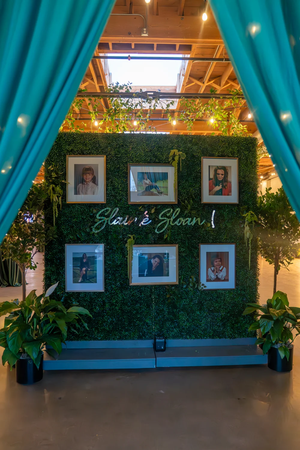 Greenery wall with photos of the birthday girl at SKYLIGHT in Denver, CO