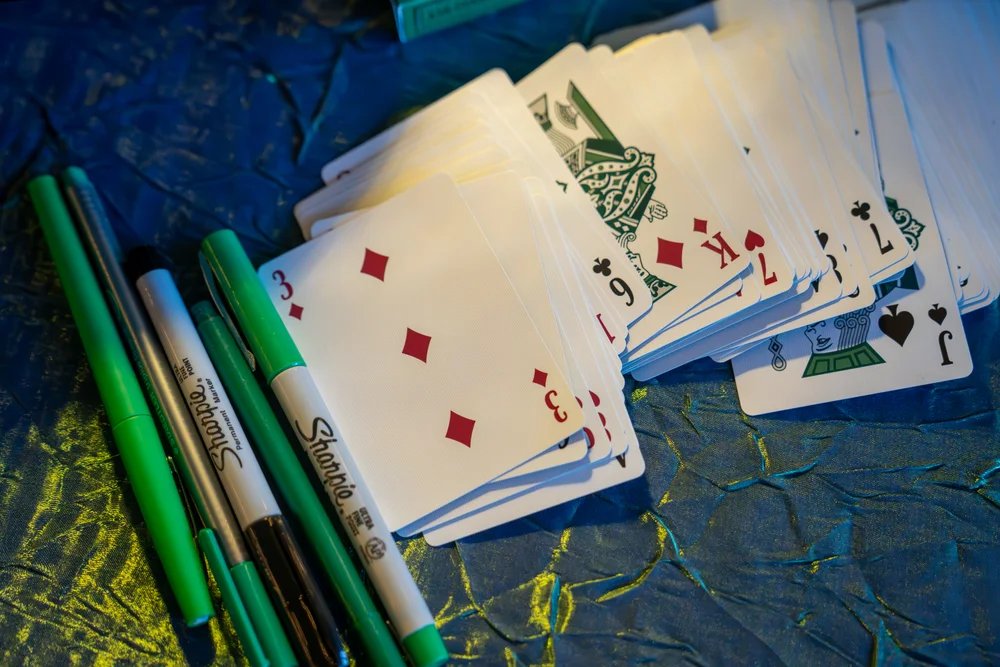Playing cards and pens set up as a guest book at SKYLIGHT in Denver, CO