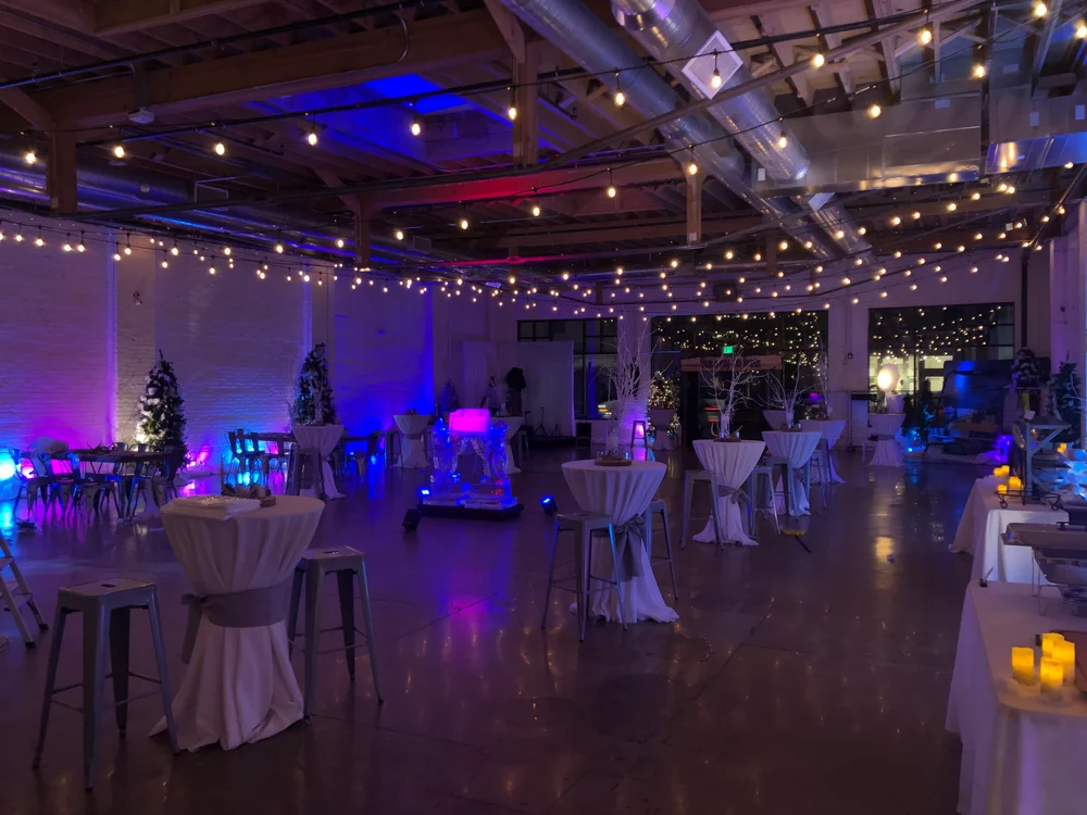 Company Holiday party at SKYLIGHT Denver with dramatic draping and cocktail tables throughout the space.