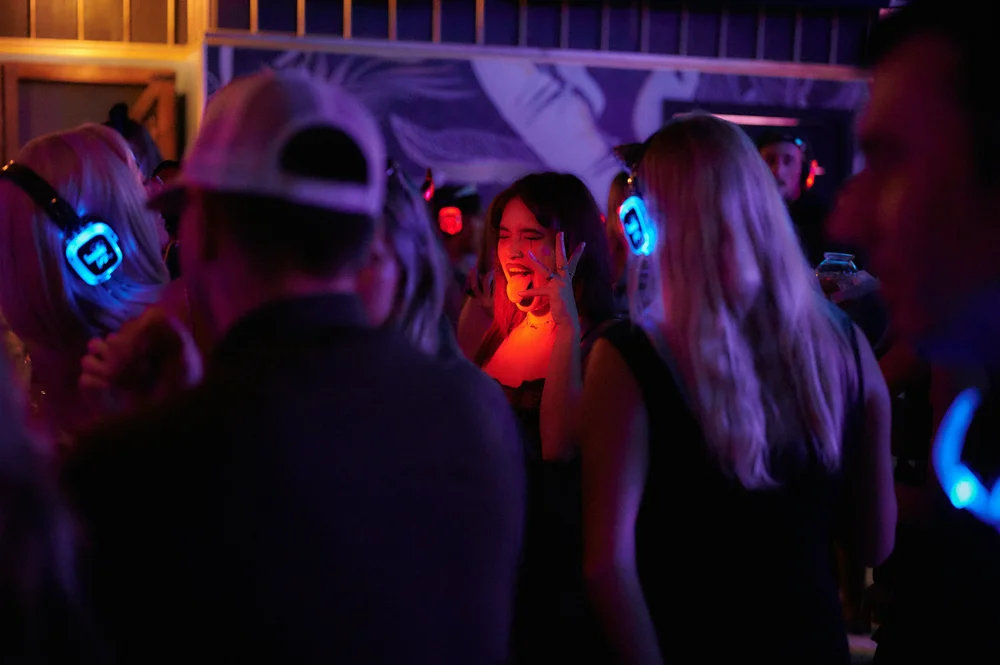 Guests enjoying a silent disco at a holiday office party at SKYLIGHT in Denver, CO