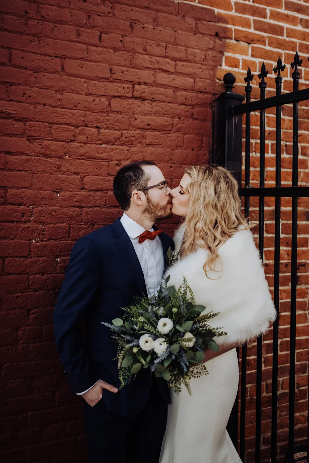 Bride and groom kissing in Denver’s Santa Fe Arts District for wedding photos