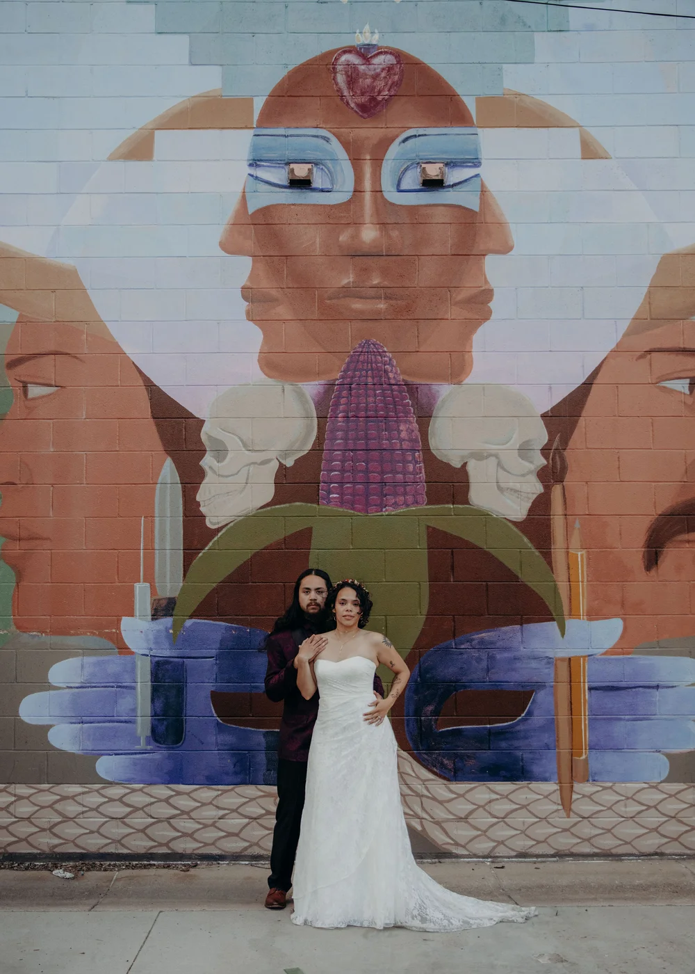 Wedding photo in the Santa Fe Arts District in Denver featuring colorful murals and urban scenery