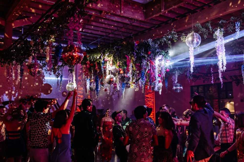 Disco-themed wedding celebration at SKYLIGHT Denver with colorful lighting and dance floor