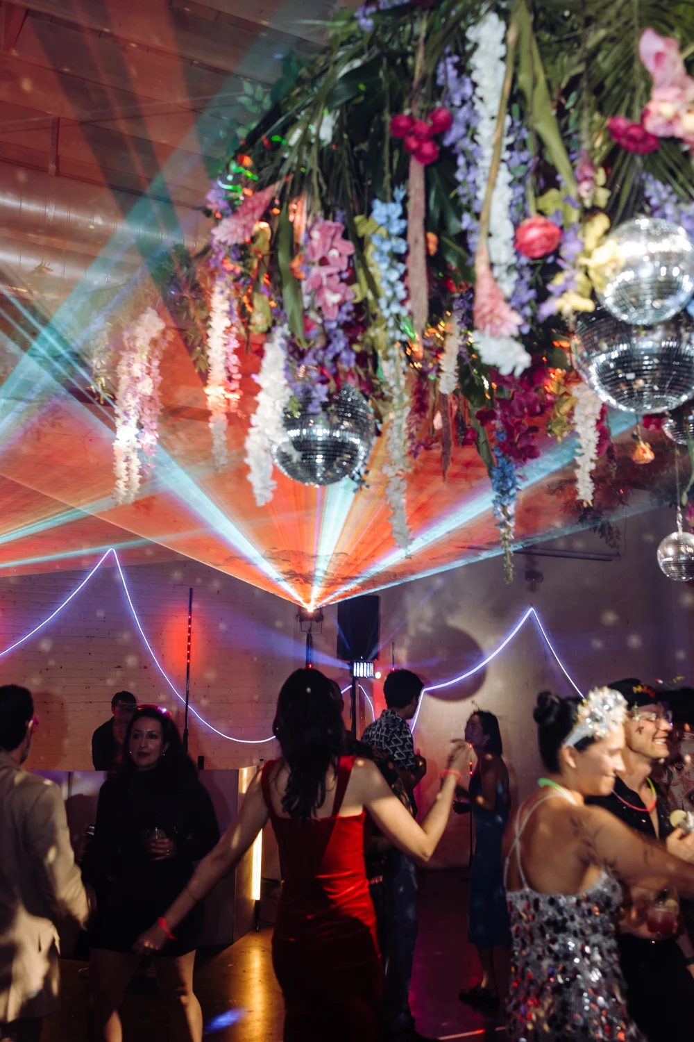 Disco rave wedding dance party at SKYLIGHT Denver with colorful lighting, lasers, and guests dancing at a high-energy nontraditional wedding