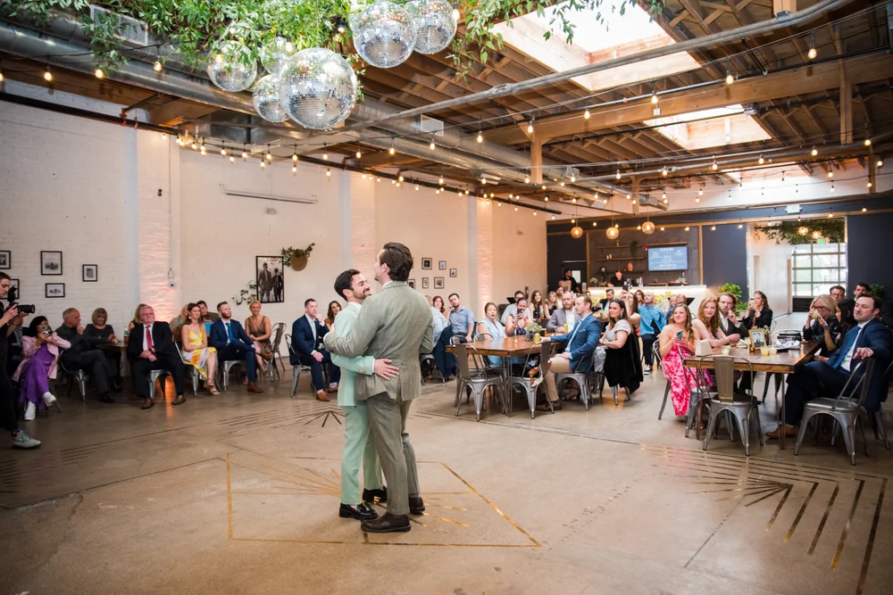 Two grooms having their first dance at SKYLIGHT in Denver
